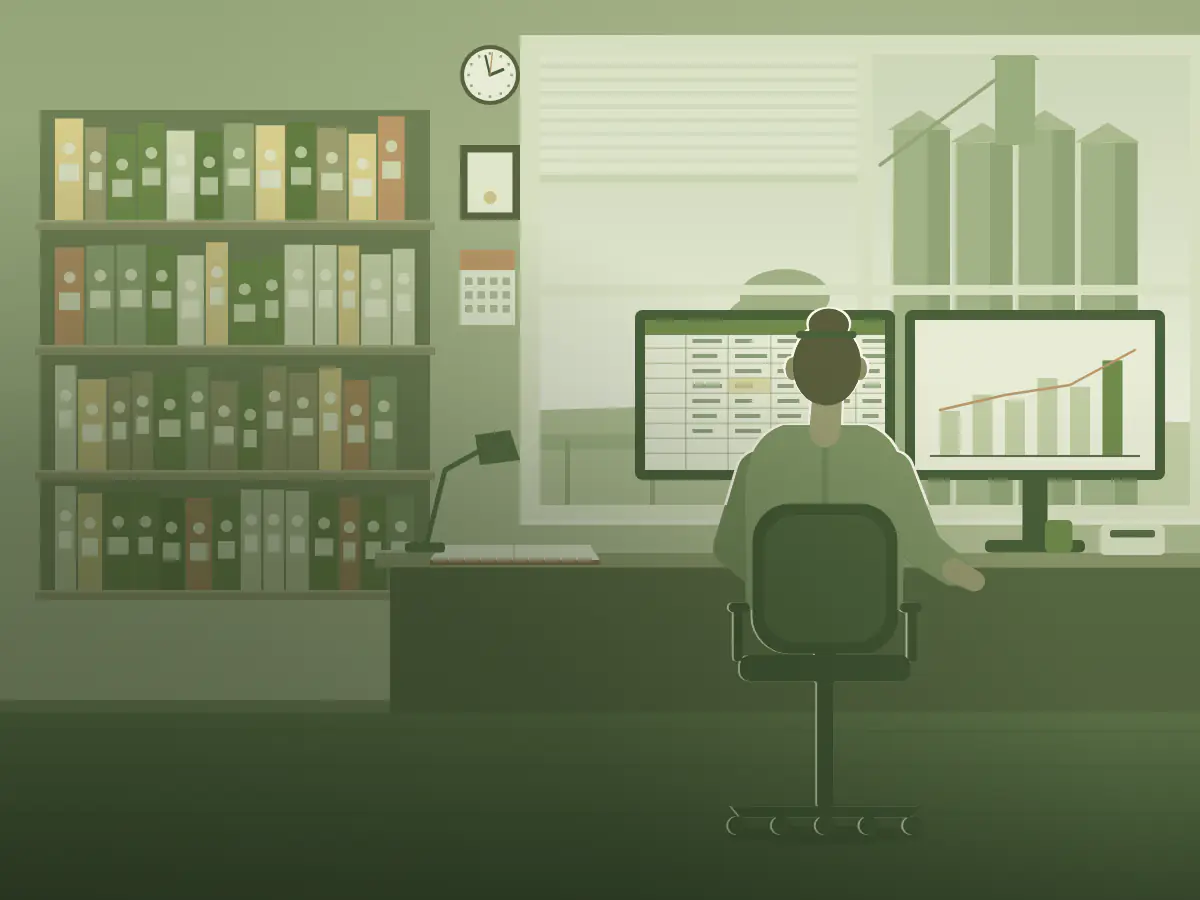 An accountant works through a client's books at her desk, grain silos in the window behind.