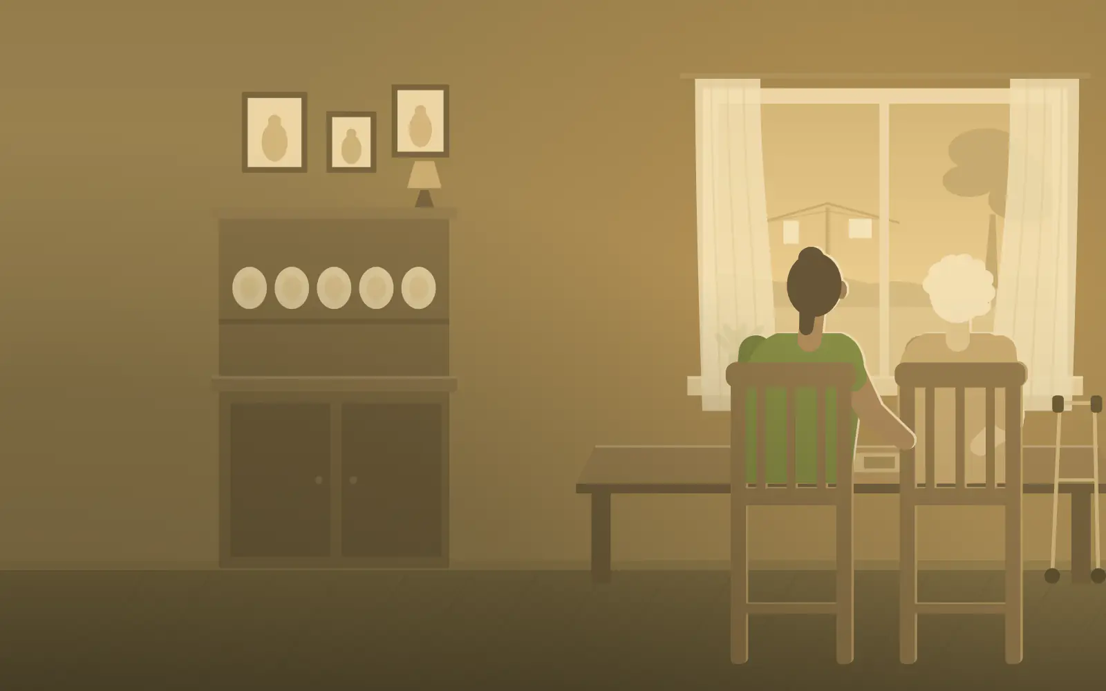A support worker and her client sit together at a kitchen table by an open window.
