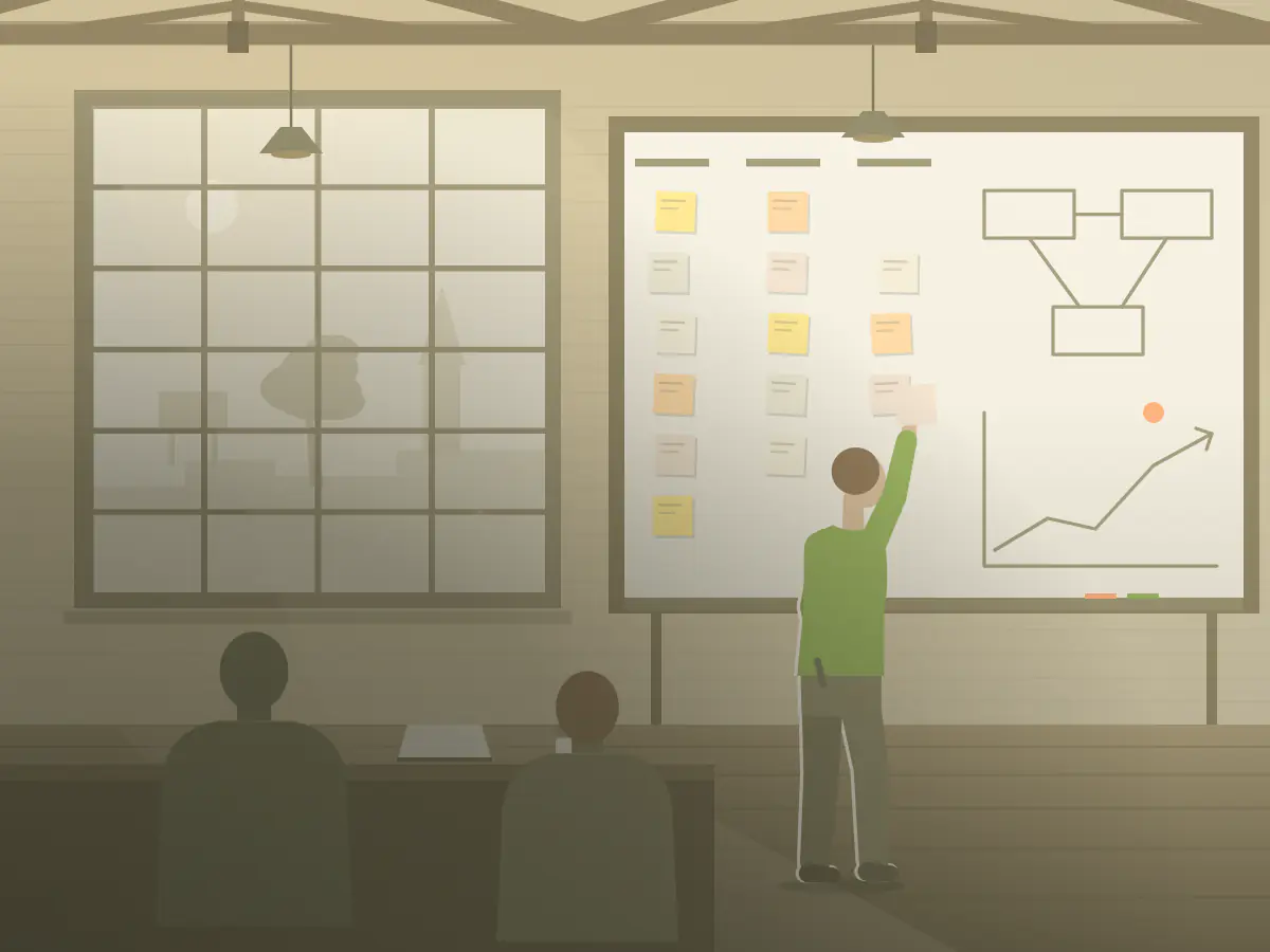 A consultant puts a sticky note up on a strategy wall for a client team in a converted woolstore.