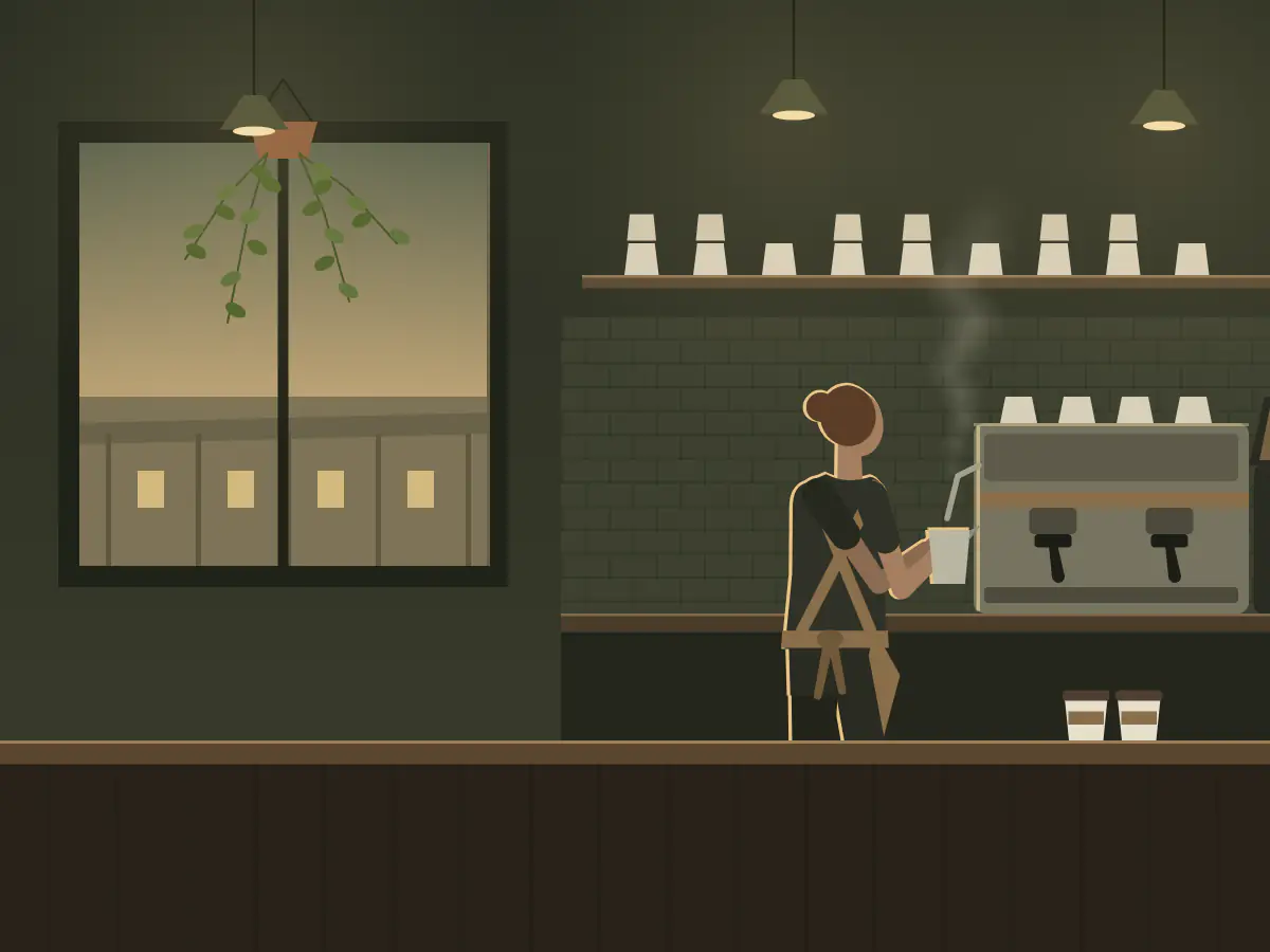 A barista steams milk at the coffee machine in a country café.