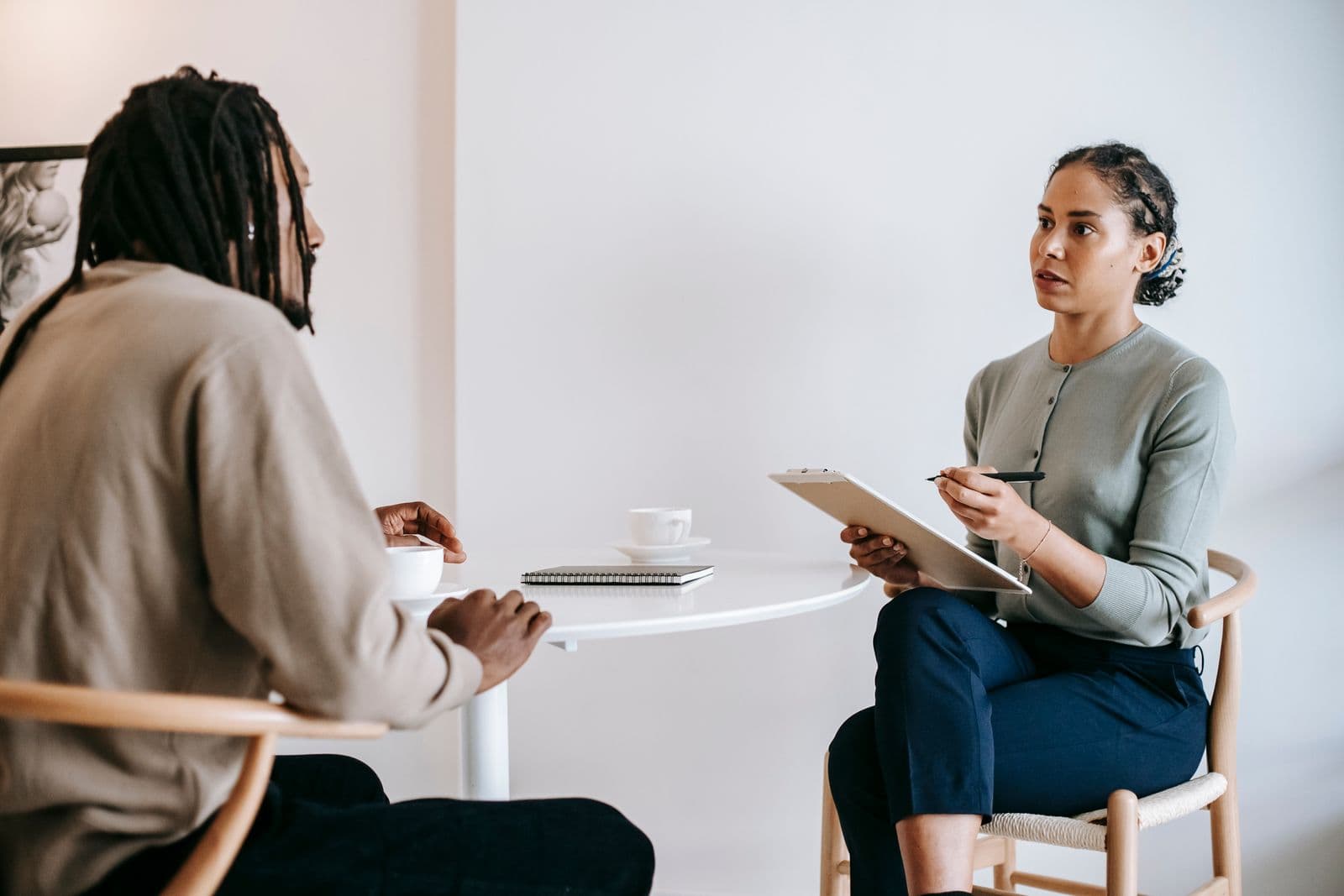 An interviewer asking a candidate questions across a small table